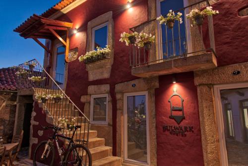 a red building with a bike parked in front of it at Hostel Bulwark in Valença