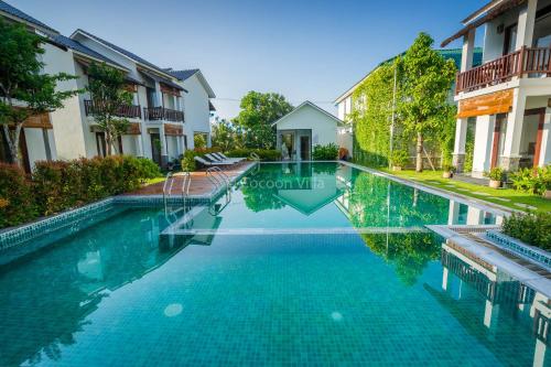 a swimming pool in the middle of a house at Cocoon Villa in Hoi An