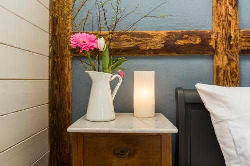 a table with a vase and a candle on it at Gutshaus Lexow in Lexow