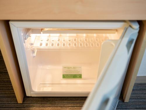 a white refrigerator with a door open at Super Hotel Asakusa in Tokyo