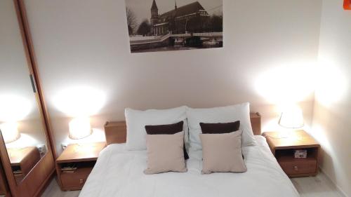 a bedroom with a white bed with two night stands at Остров Канта in Kaliningrad