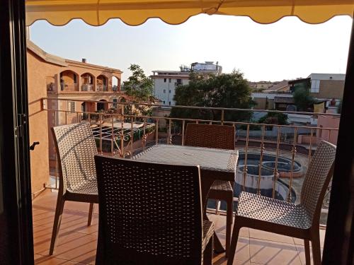 a table and chairs on a balcony with a view at Casa Vacanze Maraldo in Marina di Camerota