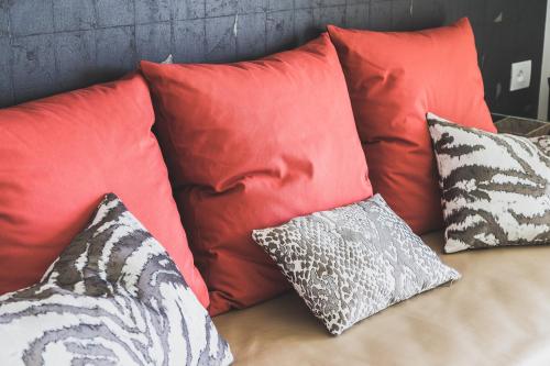 a bunch of pillows sitting on a couch at Hedoné Design Experience B&B in Agrigento