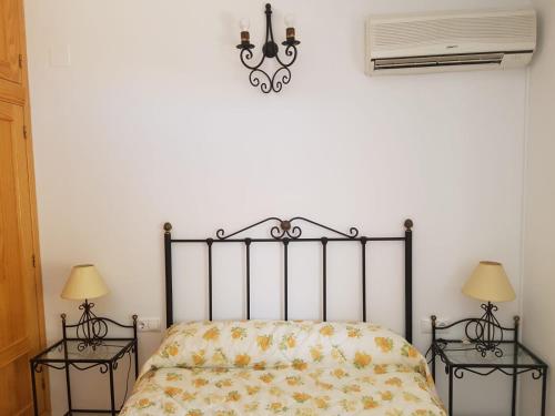 a bedroom with a bed with two night stands at Casa Esteban in Cazorla
