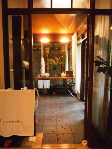 a hallway of a bathroom with a sink and a table at Mandala Spa & Resort Villas in Boracay