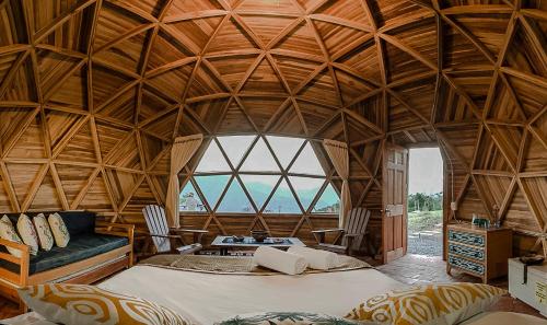 a large bedroom with a large wooden ceiling at Serrania del Viento in Barichara