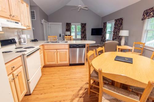 a kitchen and dining room with a table and chairs at Kentucky Dam Village State Resort Park in Gilbertsville
