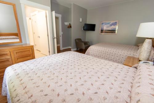 a hotel room with two beds and a mirror at Kentucky Dam Village State Resort Park in Gilbertsville