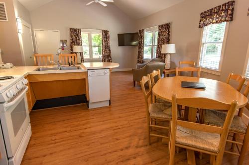 a kitchen and dining room with a table and a dining room at Kentucky Dam Village State Resort Park in Gilbertsville