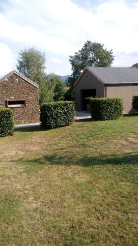 a house with a garage and a grass yard at Gospodarstwo Agroturystyczne-Pensjonat SAD in Podgórzyn