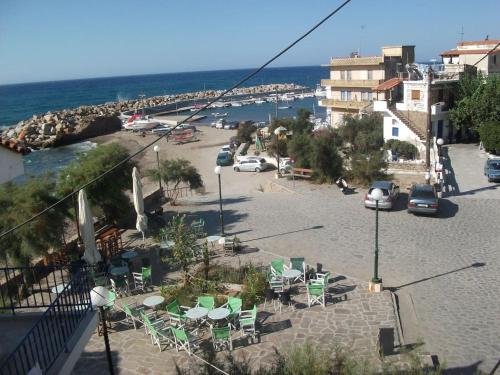 a view of a beach with chairs and the ocean at The Light Blue House in Karavostamo