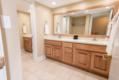 a bathroom with two sinks and a large mirror at Kentucky Dam Village State Resort Park in Gilbertsville