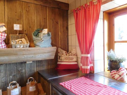 a room with wooden walls and a window and a table at Thoamlhof in Leutasch