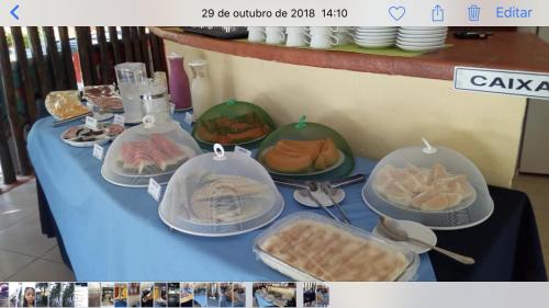 a table with bowls and plates of food on it at Pipa Flat Solar in Pipa