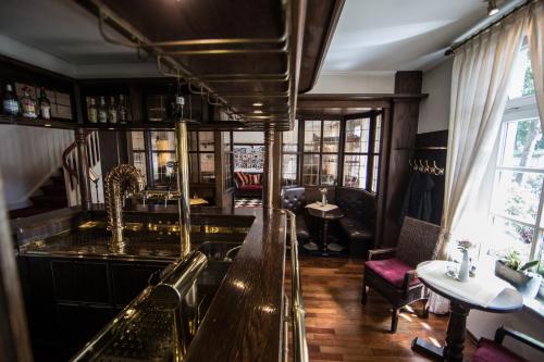 a bar in a pub with a table and chairs at Altes Landhaus in Lingen