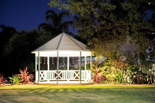 a white gazebo in the middle of a yard at The Aston Motel Tamworth in Tamworth