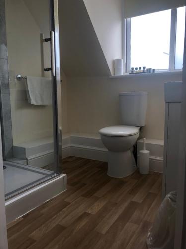 a bathroom with a toilet and a glass shower at Worthing Rest in Worthing