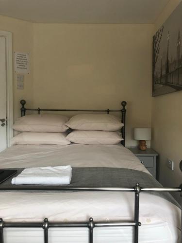 a bed with pillows on it in a bedroom at Worthing Rest in Worthing