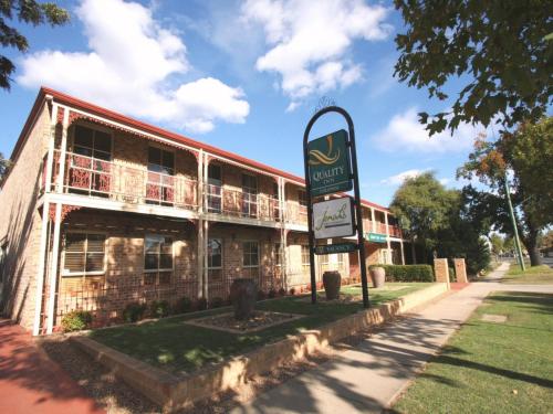 an old brick building with a sign in front of it at Quality Inn Colonial in Bendigo