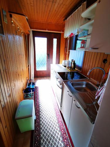 a kitchen with a sink and a counter top at MERIKOTKA - a cozy wooden cottage, sLOVEnia in Braslovče