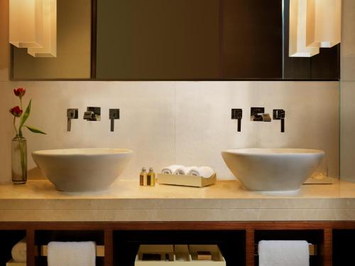 two white sinks on a counter in a bathroom at Jumeirah Himalayas Hotel Shanghai in Shanghai