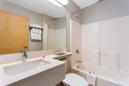 a bathroom with a sink and a toilet and a tub at Microtel Inn & Suites by Wyndham Philadelphia Airport in Philadelphia