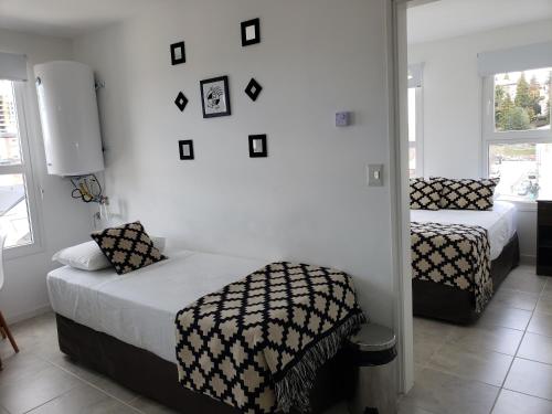 a bedroom with two beds and a mirror at Bariloche Modern Apartment in San Carlos de Bariloche