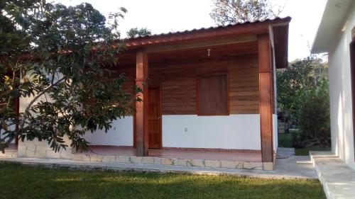 a wooden garage with a white garage door at Ciudad de Las Rocas in La Fortuna Gallo Giro
