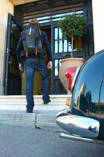 a man with a backpack walking out of a building at Doña Ruidera in Ruidera