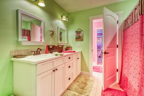 a bathroom with a sink and a pink shower at Aloha At Lake Chelan in Manson