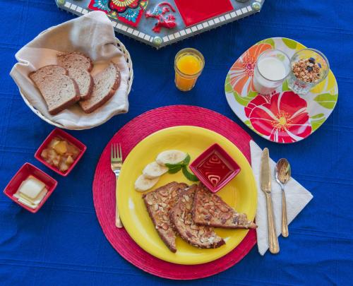 a table with a plate of food with bread and eggs at Quinta Maria en la Ruta del Vino in Valle de Guadalupe