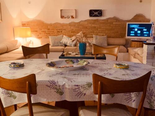 a living room with a table and chairs and a couch at Casa delle Galee in Scilla
