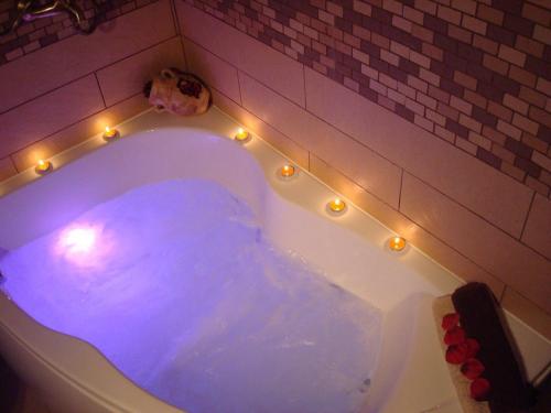 a bath tub with lights and a dog sitting in it at Casa Rural El Planet de Maella Casa rural en Castellon Casa rural con Jacuzzi Casa rural en Xert Casa rural cerca de Morella in Xert