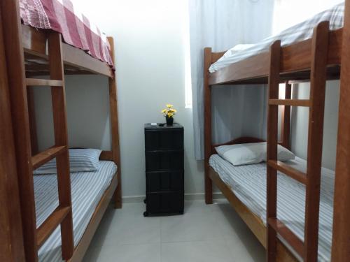 1 dormitorio con 2 literas y armario negro en Cantinho Da Del, en Recife