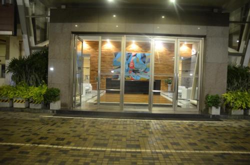 a lobby of a building with a large glass door at Atrium - ICONIC APARTMENT in Sri Jayewardenepura Kotte