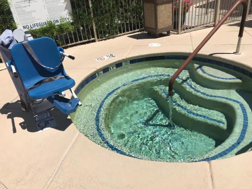 a swimming pool with a water hose in a chair at Hilton Vacation Club Varsity Club Tucson in Tucson