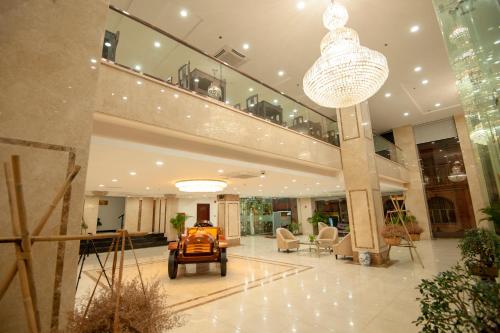 a lobby of a building with a chandelier at Cuu Long Hotel in My Tho