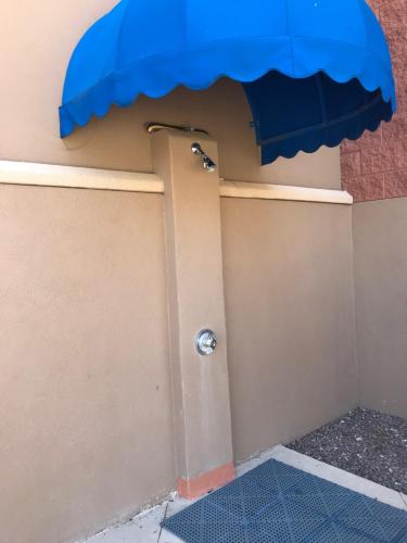 a door with a blue awning on a building at Hilton Vacation Club Varsity Club Tucson in Tucson