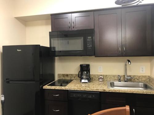 a kitchen with black appliances and a sink at Hilton Vacation Club Varsity Club Tucson in Tucson
