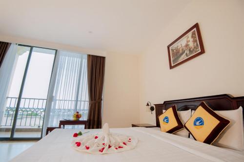 a hotel room with a bed with a large window at Cuu Long Hotel in My Tho
