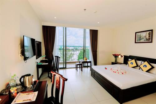 a hotel room with a bed and a large window at Cuu Long Hotel in My Tho