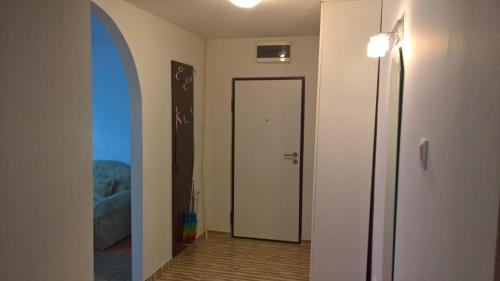 a room with a hallway with a door and a mirror at Apartman centar lux in Tuzla