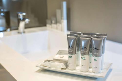 a group of four tubes of toothbrushes sitting on a bathroom counter at Dazzler by Wyndham Lima San Isidro in Lima