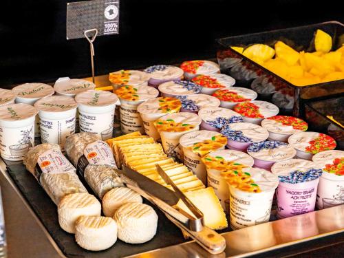 a display of cheese and other foods on a buffet at Hotel Mercure Blois Centre in Blois