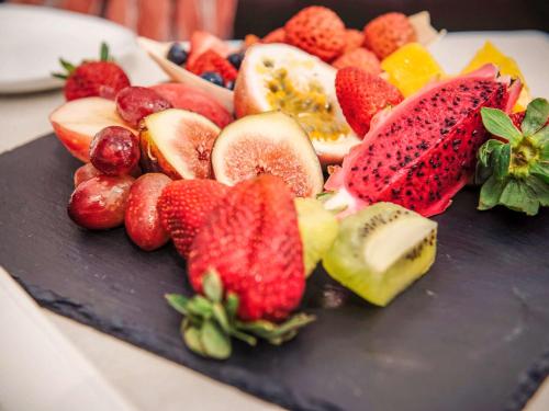 a plate of strawberries and fruit on a table at Sofitel Noosa Pacific Resort in Noosa Heads