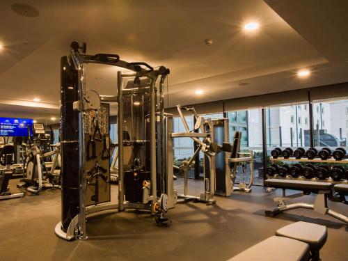 a gym with treadmills and machines in a building at Pullman Sydney Airport in Sydney