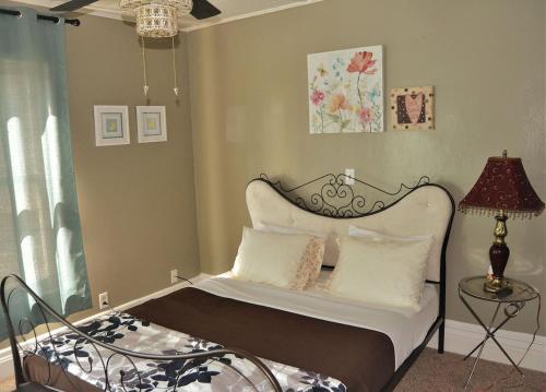 a bedroom with a bed with a headboard and a lamp at Riverside in Grand Forks