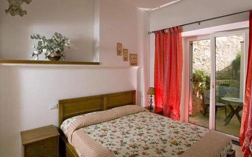 a bedroom with a bed and a sliding glass door at B&B Angelide in Anacapri