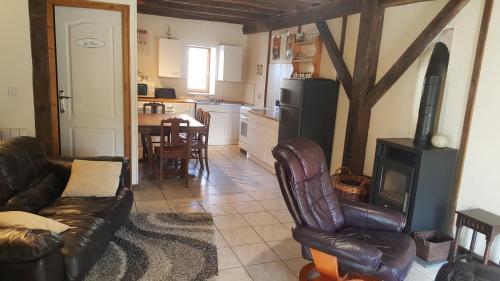 a living room with a couch and a stove at gitesdecampagne in Saint-Étienne-de-Fursac