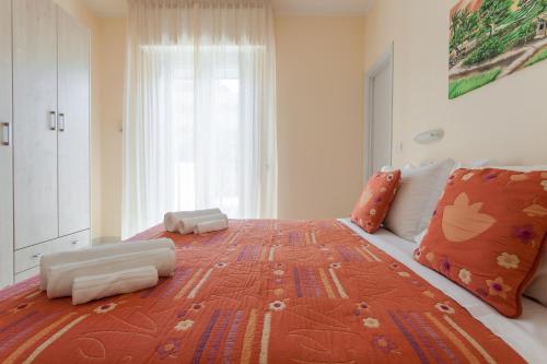 a large bed in a bedroom with a large window at Hotel Giove dipendenza Hotel Fiamma in Cesenatico